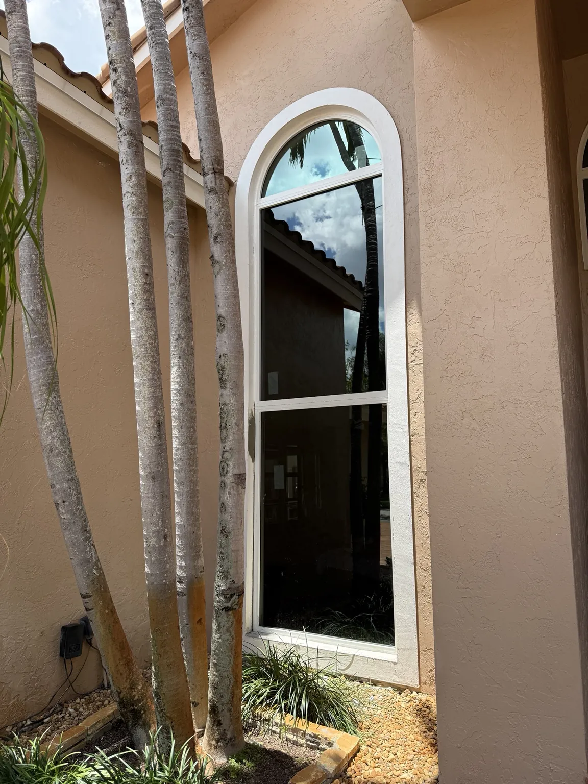 Completed tall arched impact window installation