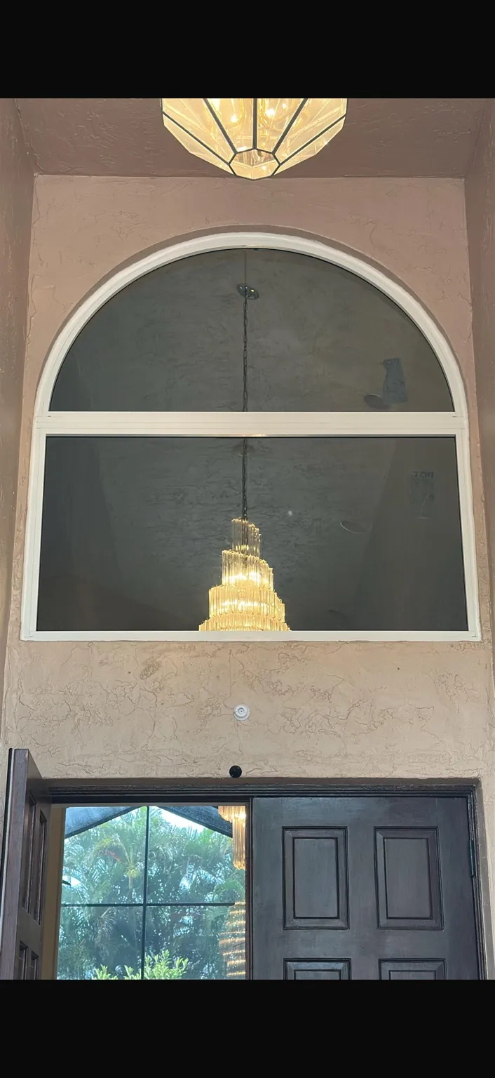 Interior view of completed arched impact window above entry doors