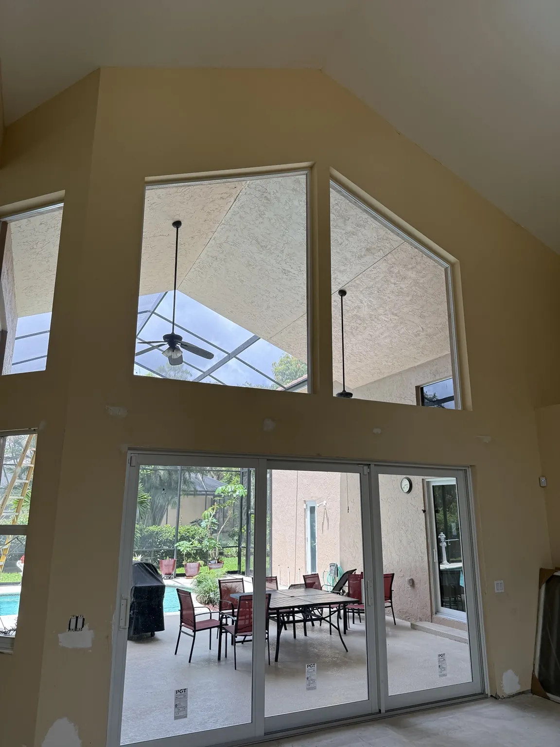Completed impact sliding glass doors with large upper picture windows